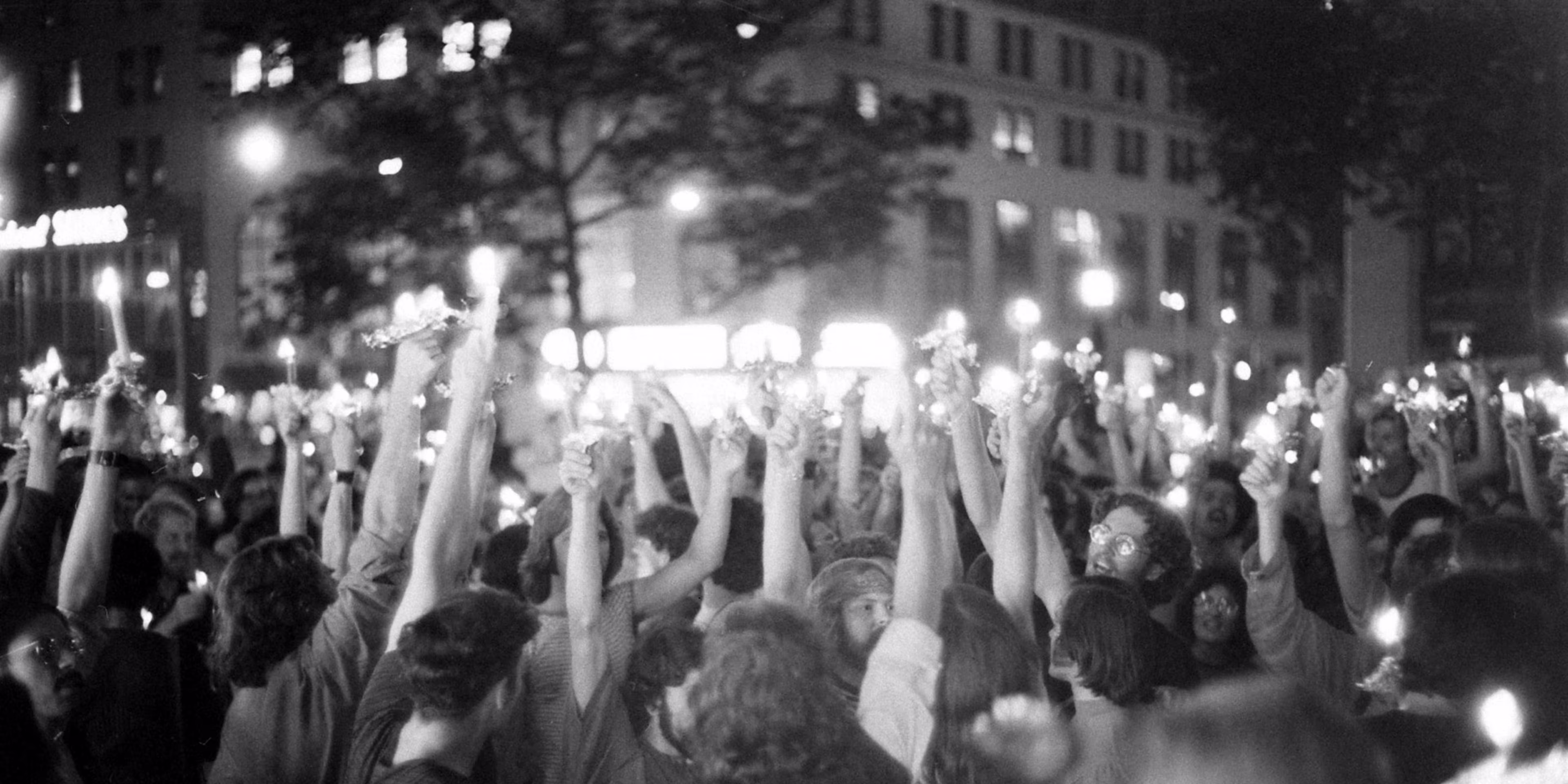 Crowd gathered outside the Stonewall Inn in New York City during the 1969 Stonewall Uprising, a pivotal moment in queer history and LGBTQIA+ resilience.